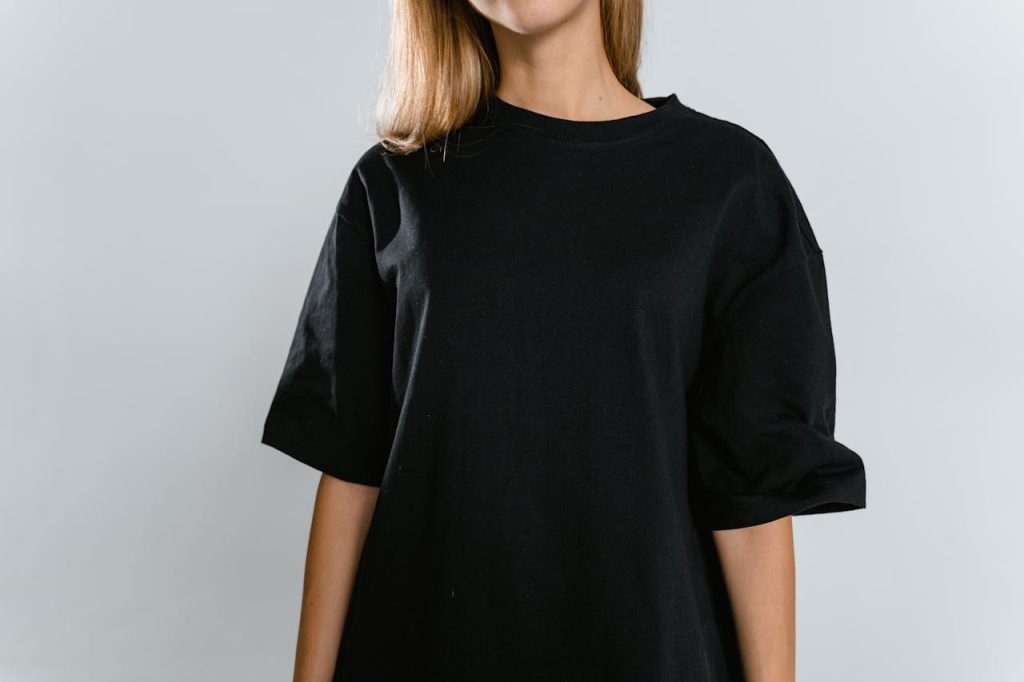 Front view of woman wearing black t-shirt with copy space on white background.
